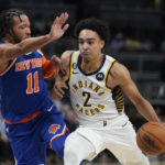 
              Indiana Pacers' Andrew Nembhard (2) goes to the basket against New York Knicks' Jalen Brunson (11) during the second half of an NBA preseason basketball game Wednesday, Oct. 12, 2022, in Indianapolis. (AP Photo/Darron Cummings)
            