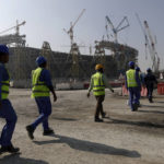 
              FILE - Workers walk to the Lusail Stadium, one of the 2022 World Cup stadiums, in Lusail, Qatar, Friday, Dec. 20, 2019. The first World Cup in the Middle East is only one month away. Qatar has been on an often bumpy 12-year journey that has transformed the nation. (AP Photo/Hassan Ammar, File)
            