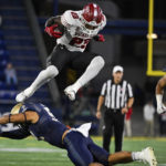 
              Temple running back Edward Saydee (23) hurdles Navy linebacker Nicholas Straw during the second half of an NCAA college football game, Saturday, Oct. 29, 2022, in Annapolis, Md. (AP Photo/Terrance Williams)
            