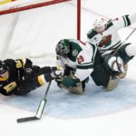 
              Boston Bruins' Tomas Nosek (92) and Minnesota Wild's Calen Addison (2) collide with Wild goalie Marc-Andre Fleury (29) during the second period of an NHL hockey game, Saturday, Oct. 22, 2022, in Boston. (AP Photo/Michael Dwyer)
            