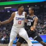 
              Los Angeles Clippers guard Paul George (13) is guarded by Sacramento Kings forward KZ Okpala (30) during the first quarter of an NBA basketball game in Sacramento, Calif., Saturday, Oct. 22, 2022. (AP Photo/Randall Benton)
            
