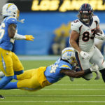
              Denver Broncos tight end Andrew Beck (83) tries to elude the tackle of Los Angeles Chargers linebacker Chris Rumph II (94) during the first half of an NFL football game, Monday, Oct. 17, 2022, in Inglewood, Calif. (AP Photo/Marcio Jose Sanchez)
            