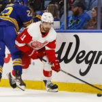 
              Detroit Red Wings right wing Filip Zadina (11) is checked by Buffalo Sabres right wing Jack Quinn (22) during the first period of an NHL hockey game, Monday, Oct. 31, 2022, in Buffalo, N.Y. (AP Photo/Jeffrey T. Barnes)
            
