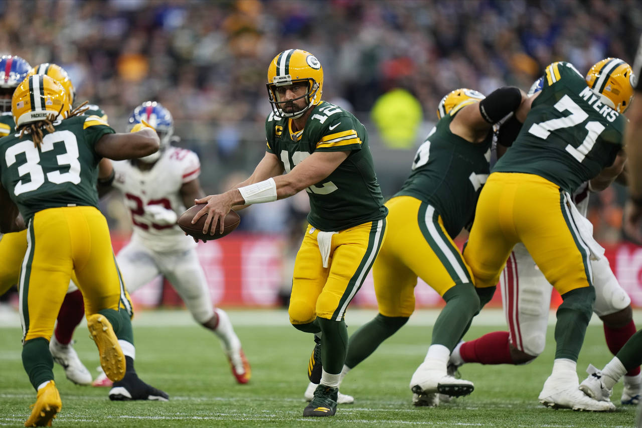 Green Bay Packers quarterback Aaron Rodgers (12) scrambles during the second half of an NFL footbal...
