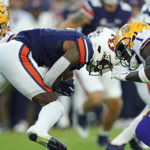 
              LSU cornerback Sevyn Banks (1) moves in to tackle Auburn cornerback Keionte Scott (6) on the opening kickoff in the first half of an NCAA college football game, Saturday, Oct. 1, 2022, in Auburn, Ala. Banks was injured on the play and was taken off the field on a cart and loaded into an ambulance. (AP Photo/John Bazemore)
            