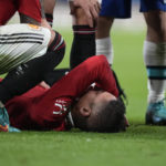 
              Manchester United's Raphael Varane lies injured on the ground during the English Premier League soccer match between Manchester United and Chelsea at the Stamford Bridge Stadium in London, Saturday, Oct. 22, 2022. (AP Photo/Frank Augstein)
            