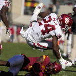
              Oklahoma running back Marcus Major (24) is tackled by Iowa State defensive back T.J. Tampa (2) during the first half of an NCAA college football game, Saturday, Oct. 29, 2022, in Ames, Iowa. (AP Photo/Charlie Neibergall)
            