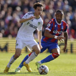 
              Leeds United's Brenden Aaronson, left, and Crystal Palace's Jordan Ayew battle for the ball during the English Premier League soccer match between Crystal Palace and Leeds United at Selhurst Park, London, Sunday Oct. 9, 2022. (Steven Paston/PA via AP)
            