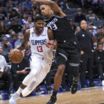 
              Los Angeles Clippers guard Paul George (13) drives against Sacramento Kings forward Keegan Murray (13) during the second half of an NBA basketball game in Sacramento, Calif., Saturday, Oct. 22, 2022. The Clippers won 111-109. (AP Photo/Randall Benton)
            