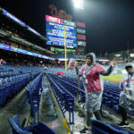 
              Fans leave Citizens Bank Park before Game 3 of baseball's World Series between the Houston Astros and the Philadelphia Phillies on Monday, Oct. 31, 2022, in Philadelphia. The game was postponed by rain Monday night with the matchup tied 1-1. (AP Photo/Matt Rourke)
            