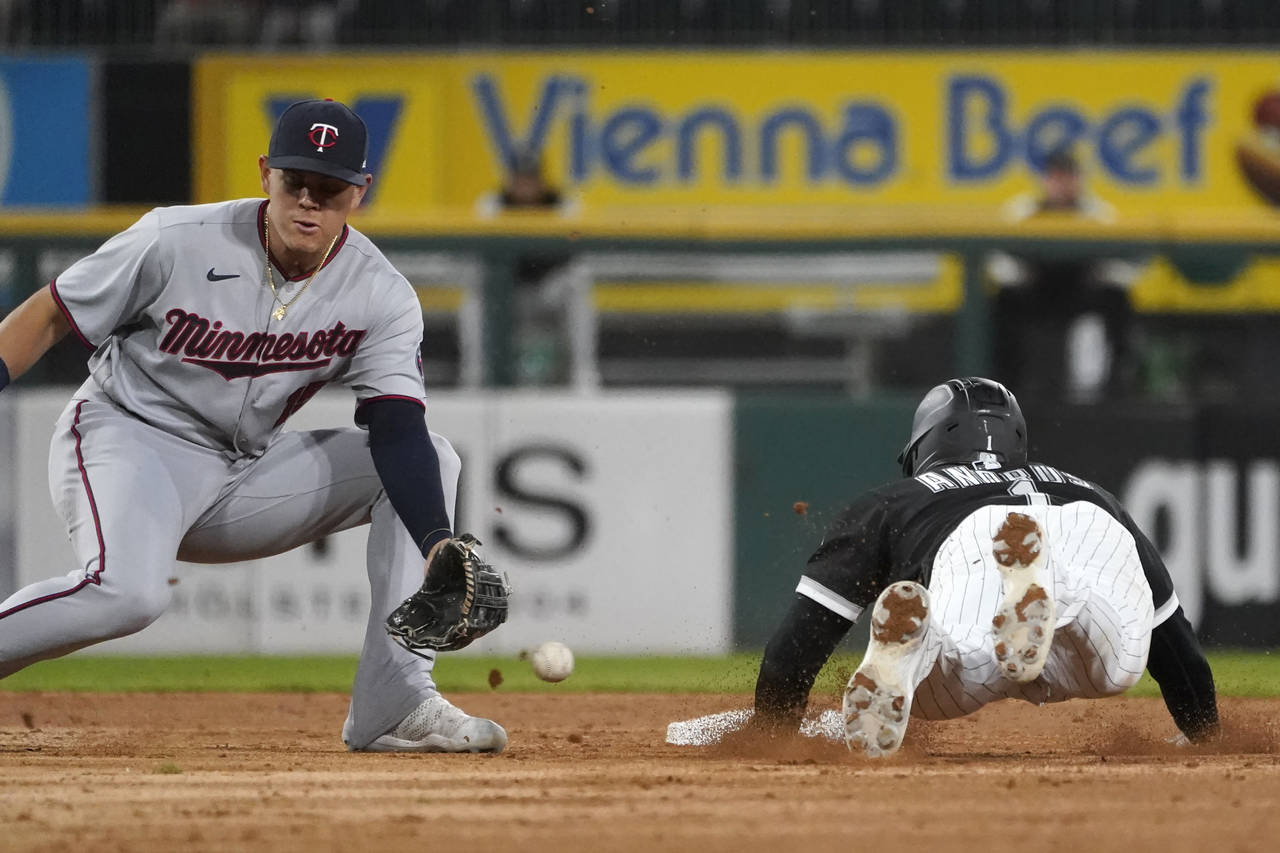 Chicago White Sox's Elvis Andrus, right, steals second as Minnesota Twins' Gio Urshela is unable to...