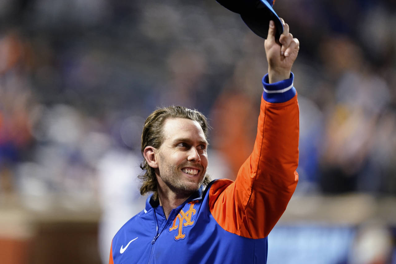 New York Mets' Jeff McNeil gestures to fans during the fourth inning of the team's baseball game ag...