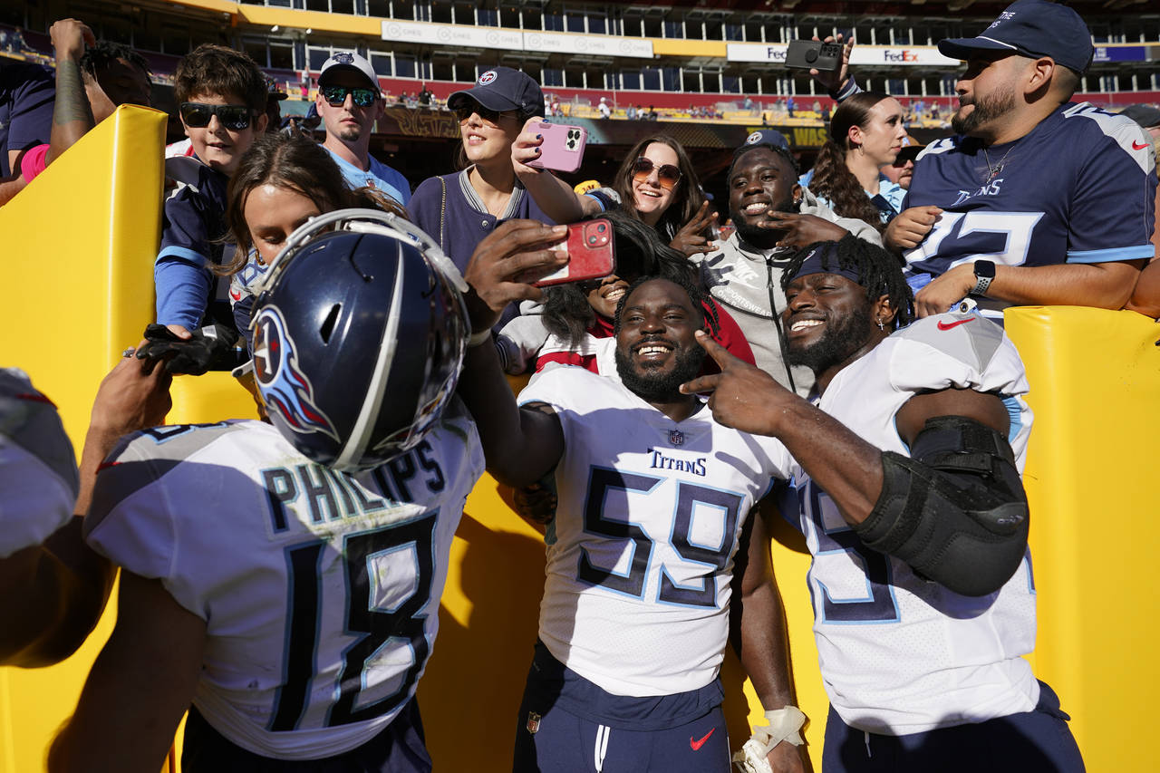 Tennessee Titans wide receiver Kyle Philips (18) defensive tackle Sam Okuayinonu (59) and tight end...