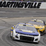 
              Chase Elliott (9) leads Christopher Bell (20) out of Turn 4 during a NASCAR Cup Series auto race at Martinsville Speedway, Sunday, Oct. 30, 2022, in Martinsville, Va. (AP Photo/Chuck Burton)
            