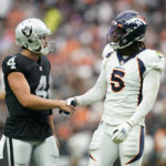 
              Las Vegas Raiders quarterback Derek Carr (4) greets Denver Broncos linebacker Randy Gregory (5) after a play during the first half of an NFL football game, Sunday, Oct. 2, 2022, in Las Vegas. (AP Photo/Abbie Parr)
            