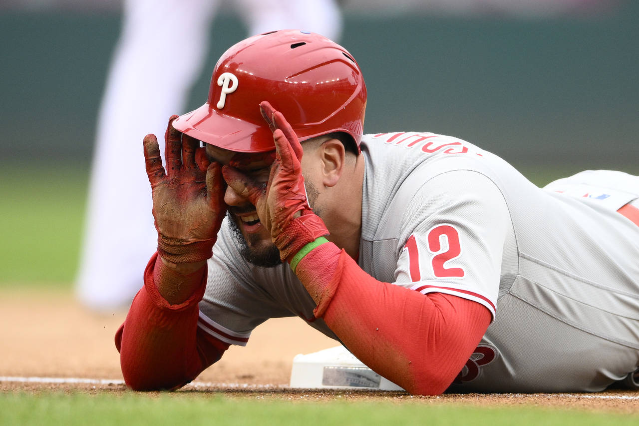 Philadelphia Phillies' Kyle Schwarber looks towards the dugout after he tripled during the first in...