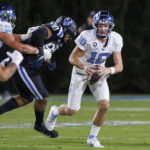 
              North Carolina's Drake Maye (10) scrambles out of the pocket during the first half of an NCAA college football game against Duke in Durham, N.C., Saturday, Oct. 15, 2022. (AP Photo/Ben McKeown)
            