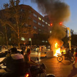 
              In this Monday, Sept. 19, 2022, photo taken by an individual not employed by the Associated Press and obtained by the AP outside Iran, a police motorcycle and a trash bin are burning during a protest over the death of Mahsa Amini, a 22-year-old woman who had been detained by the nation's morality police, in downtown Tehran, Iran. Spontaneous mass gatherings to persistent scattered demonstrations have unfolded elsewhere in Iran, as nationwide protests over the death of a young woman in the custody of the morality police enter their fourth week.(AP Photo)
            