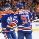 
              Edmonton Oilers' Zach Hyman (18) and Ryan Nugent-Hopkins (93) celebrate a goal against the Pittsburgh Penguins during second-period NHL hockey game action in Edmonton, Alberta, Monday, Oct. 24, 2022. (Jason Franson/The Canadian Press via AP)
            