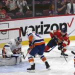 
              Florida Panthers' Anton Lundell (15) watches the puck slip past New York Islanders goalie Semyon Varlamov, left, during the first period of an NHL hockey game, Sunday, Oct. 23, 2022, in Sunrise, Fla. (AP Photo/Michael Laughlin)
            