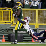 
              Green Bay Packers wide receiver Romeo Doubs looks to catch a pass ahead of New England Patriots cornerback Jonathan Jones, right, in the end zone during the second half of an NFL football game, Sunday, Oct. 2, 2022, in Green Bay, Wis. The pass was ruled incomplete. (AP Photo/Matt Ludtke)
            