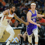 
              Sacramento Kings guard Kevin Huerter (9) drives as Phoenix Suns guard Duane Washington Jr. (4) defends during the first half of an NBA preseason basketball game, Wednesday, Oct. 12, 2022, in Phoenix. (AP Photo/Matt York)
            