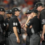 
              Officials confer during the fifth inning in Game 2 of baseball's World Series between the Houston Astros and the Philadelphia Phillies on Saturday, Oct. 29, 2022, in Houston. (AP Photo/David J. Phillip)
            