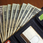 
              FILE - Cash is fanned out from a wallet in North Andover, Mass., June 15, 2018. The U.S. economy grew faster than expected in the July-September 2022 quarter, the government reported Thursday, Oct. 27, 2022, underscoring that the United States is not in a recession despite distressingly high inflation and interest rate hikes by the Federal Reserve. But the economy is hardly in the clear. (AP Photo/Elise Amendola, File)
            