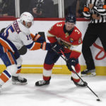 
              RETRANSMISSION TO CORRECT YEAR - New York Islanders' Cal Clutterbuck (15) defends Florida Panthers' Matt Keirsted (3) during the first period of an NHL hockey game, Sunday, Oct. 22, 2022, in Sunrise, Fla. (AP Photo/Michael Laughlin)
            