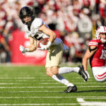 
              Purdue wide receiver Charlie Jones (15) runs against Wisconsin safety John Torchio during the first half of an NCAA college football game Saturday, Oct. 22, 2022, in Madison, Wis. (AP Photo/Andy Manis)
            