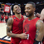 
              Portland Trail Blazers guard Anfernee Simons, left, and guard Damian Lillard smile after the team's win in an NBA basketball game against the Phoenix Suns in Portland, Ore., Friday, Oct. 21, 2022. (AP Photo/Craig Mitchelldyer)
            