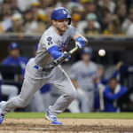 
              Los Angeles Dodgers' Trea Turner hits a bunt single during the seventh inning in Game 4 of a baseball NL Division Series against the Los Angeles Dodgers, Saturday, Oct. 15, 2022, in San Diego. (AP Photo/Ashley Landis)
            