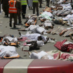
              FILE - Bodies of people who died in a crush in Mina, Saudi Arabia during the annual hajj pilgrimage lie in a street, Sept. 24, 2015. (AP Photo/File)
            