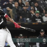 
              Chicago White Sox's Eloy Jimenez hits an RBI double off Minnesota Twins starting pitcher Josh Winder during the third inning of a baseball game Tuesday, Oct. 4, 2022, in Chicago. (AP Photo/Charles Rex Arbogast)
            