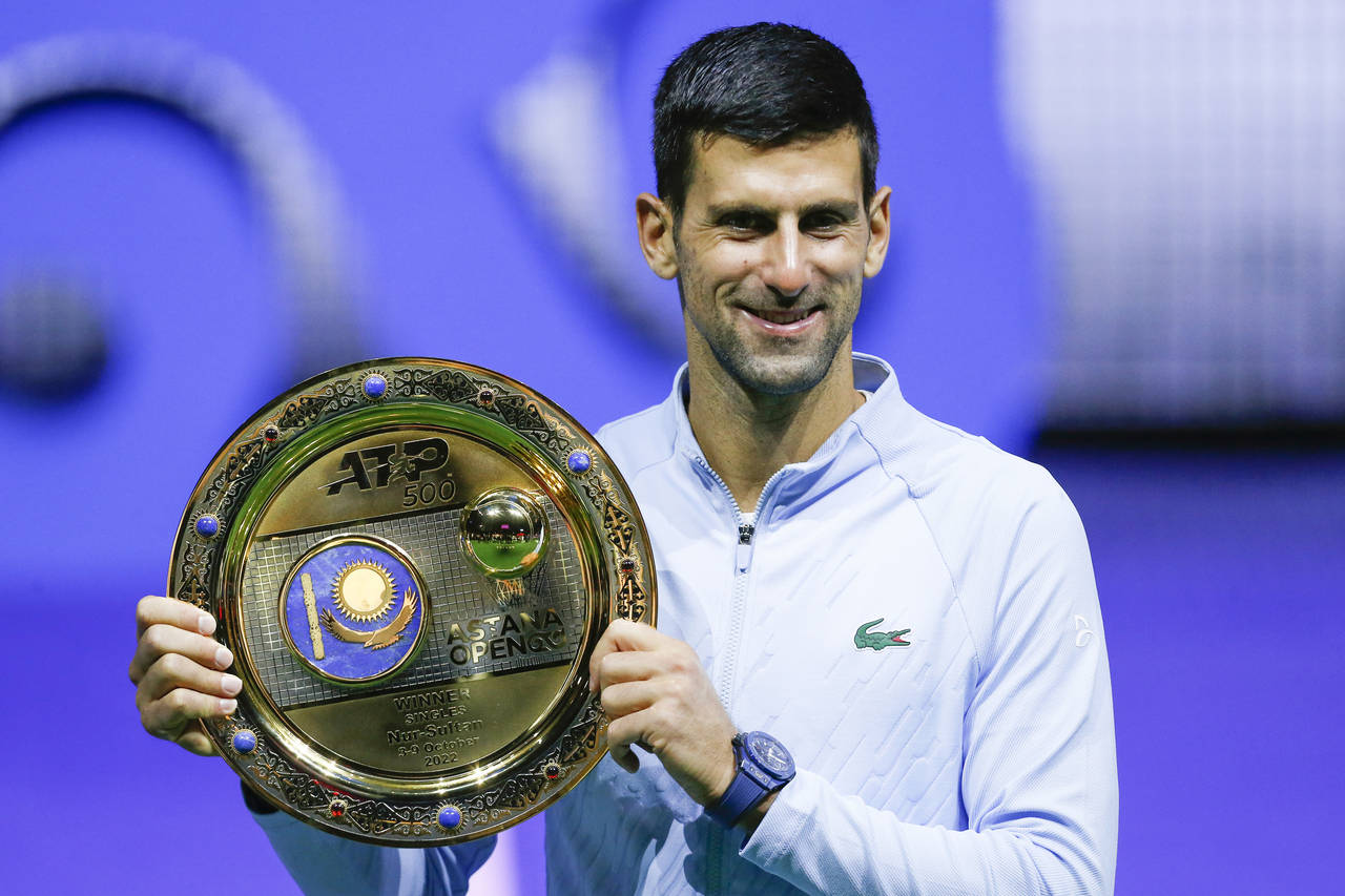 Serbia's Novak Djokovic poses with the trophy after winning the final tennis match of the ATP 500 A...