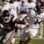 
              Texas A&M quarterback Max Johnson is pursued by Mississippi State linebacker Nathaniel Watson during the first half of an NCAA college football game in Starkville, Miss., Saturday, Oct. 1, 2022. (AP Photo/Rogelio V. Solis)
            