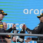 
              Red Bull driver Max Verstappen, left, of the Netherlands, and Mercedes driver Lewis Hamilton, right, of Britain, celebrate on the podium after the Formula One U.S. Grand Prix auto race at Circuit of the Americas, Sunday, Oct. 23, 2022, in Austin, Texas. Verstappen won the race and Hamilton finished second. (AP Photo/Charlie Neibergall)
            