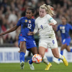 
              United States' Naomi Girma, left, challenges for the ball with England's Lauren Hemp during the women's friendly soccer match between England and the US at Wembley stadium in London, Friday, Oct. 7, 2022. (AP Photo/Kirsty Wigglesworth)
            