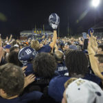 
              Georgia Southern fans and players celebrate at midfield after defeating James Madison during an NCAA football game, Saturday, Oct. 15, 2022, in Statesboro, Ga.. (AP Photo/Stephen B. Morton)
            