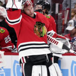 
              Chicago Blackhawks goaltender Alex Stalock puts on his helmet during the first period of an NHL hockey game against the Seattle Kraken in Chicago, Sunday, Oct. 23, 2022. (AP Photo/Nam Y. Huh)
            