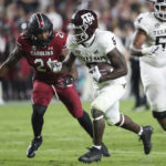 
              Texas A&M running back Devon Achane (6) pulls away from South Carolina defensive back Nick Emmanwori (21) during the second half of an NCAA college football game Saturday, Oct. 22, 2022, in Columbia, S.C. (AP Photo/Artie Walker Jr.)
            