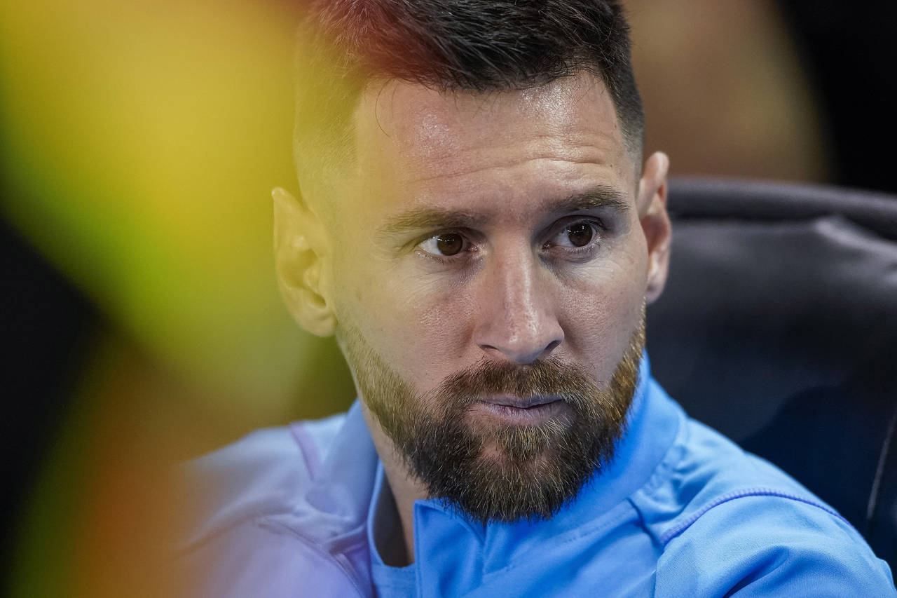 Argentina forward Lionel Messi sits before the team's international friendly soccer match against J...