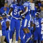 
              Kentucky linebacker D'Eryk Jackson (54) celebrates with linebacker Trevin Wallace (32) after forcing a turnover by South Carolina during the first half of an NCAA college football game in Lexington, Ky., Saturday, Oct. 8, 2022. (AP Photo/Michael Clubb)
            