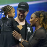 
              FILE - Serena Williams talks with her daughter Olympia and husband Alexis Ohanian after defeating Danka Kovinic, of Montenegro, during the first round of the U.S. Open tennis championships, Aug. 29, 2022, in New York. Alexis Ohanian called out the need for a safe work environment in the National Women's Soccer League while receiving the Champions for Equality Award at the annual Salute to Women in Sports event on Wednesday night, Oct. 12. (AP Photo/Charles Krupa, File)
            