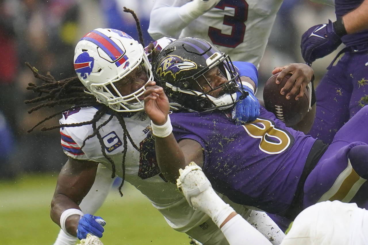 Baltimore Ravens quarterback Lamar Jackson (8) is brought down by Buffalo Bills linebacker Tremaine...