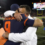 
              Illinois head coach Bret Bielema hugs quarterback Artur Sitkowski after the team's 9-6 win over Iowa in an NCAA college football game Saturday, Oct. 8, 2022, in Champaign, Ill. (AP Photo/Charles Rex Arbogast)
            