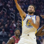
              Golden State Warriors guard Stephen Curry, foreground, shoots in front of Miami Heat forward Jimmy Butler during the first half of an NBA basketball game in San Francisco, Thursday, Oct. 27, 2022. (AP Photo/Jeff Chiu)
            