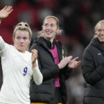 
              England's Lauren Hemp, left, waves to supporters after the women's friendly soccer match between England and the US at Wembley stadium in London, Friday, Oct. 7, 2022. (AP Photo/Kirsty Wigglesworth)
            