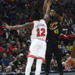 
              Cleveland Cavaliers' Donovan Mitchell (45) goes up to shoot against Chicago Bulls' Ayo Dosunmu (12 during the first half of an NBA basketball game Saturday, Oct. 22, 2022, in Chicago. (AP Photo/Paul Beaty)
            