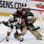 
              Minnesota Wild defenseman Jared Spurgeon (46) watches the puck as he ties up Ottawa Senators right wing Mathieu Joseph (21) in front of Wild goaltender Marc-Andre Fleury during second-period NHL hockey game action, Thursday, Oct. 27, 2022 in Ottawa. (Adrian Wyld/The Canadian Press via AP)
            